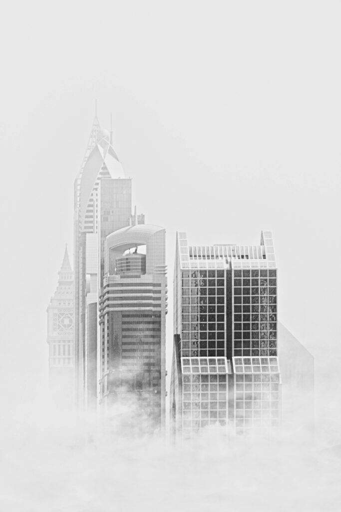 Home Stunning black and white photo of modern Dubai skyscrapers rising through fog.