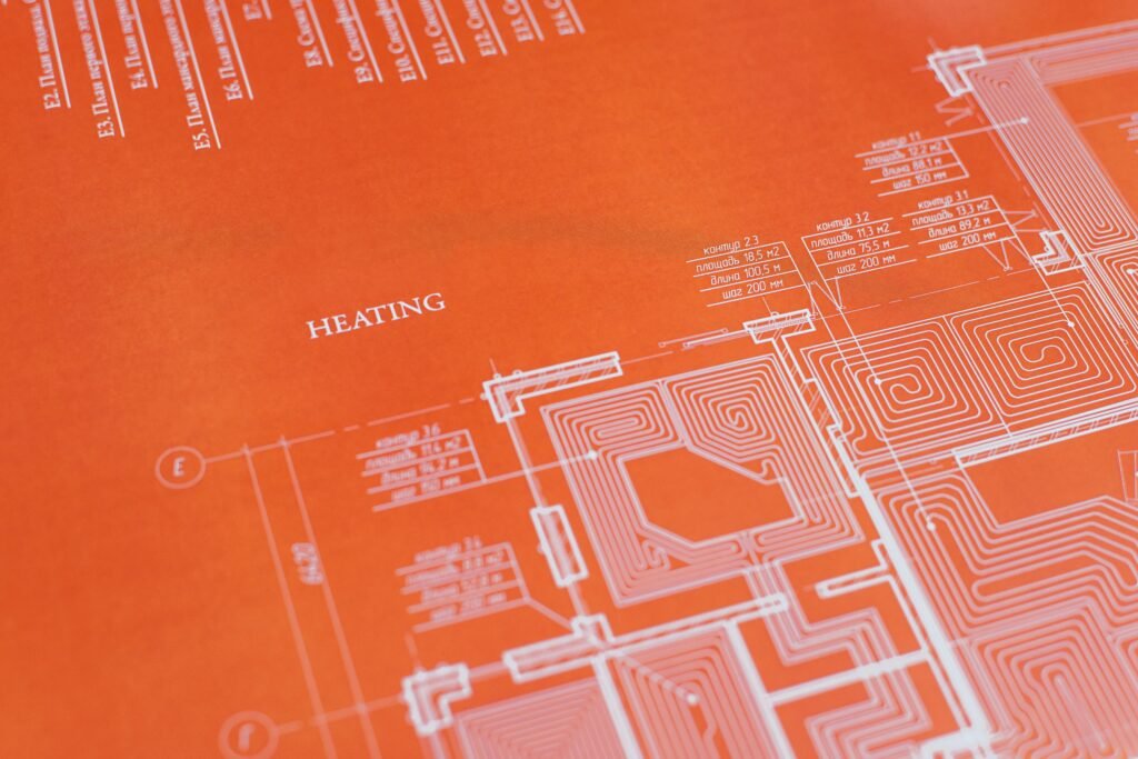 Close-up of an orange architectural heating blueprint showing intricate design details.